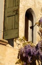 Small window with wisteria flowers in Asolo