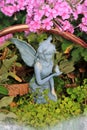 Fairy in a Garden with Small Bird in Hand