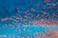 Small wisps of golden clouds on a blue sky Royalty Free Stock Photo