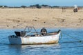 Small withe boat at low tide