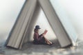 Small woman reading a book law protected by a house made from a giant book Royalty Free Stock Photo