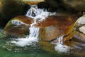 Small wonderful refreshing waterfalls among the rocks of mountain creek Royalty Free Stock Photo