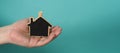 Small wood house in hands represent concepts such as home care family love Royalty Free Stock Photo