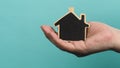 Small wood house in hands represent concepts such as home care family love Royalty Free Stock Photo