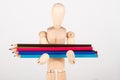 Small wood mannequin standing with colour pencil Royalty Free Stock Photo