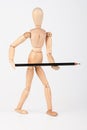 Small wood mannequin standing with colour pencil isolated on white Royalty Free Stock Photo