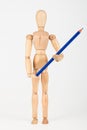 Small wood mannequin standing with colour pencil isolated on white Royalty Free Stock Photo