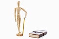 Small wood mannequin standing with pencil and calendar on white background Royalty Free Stock Photo
