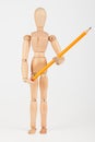 Small wood mannequin standing with pencil Royalty Free Stock Photo