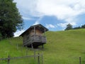 Small wooden alpine style house on the hill Royalty Free Stock Photo