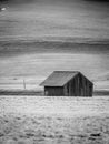 small wooden barn on the field in winter Royalty Free Stock Photo