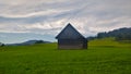 Small wooden barn in the middle of the grassland in the alpine area