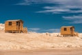 Small wooden bathing house on a white sandy beach. Royalty Free Stock Photo
