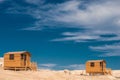 Small wooden bathing house on a white sandy beach. Royalty Free Stock Photo