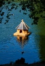 Small wooden birdhouse in the middle of a lake Royalty Free Stock Photo
