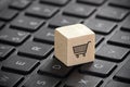 Wooden block with shopping cart graphic on laptop keyboard. Online shopping concept. Royalty Free Stock Photo