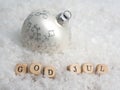 Small wooden blocks with the Scandinavian inscription Merry Christmas in the snow Royalty Free Stock Photo