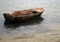 Small wooden boat anchored on the beach