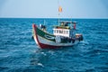 Small wooden boat fishing in the sea