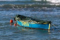 A small wooden boat with ground cloth anchored in the bay Royalty Free Stock Photo