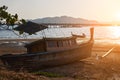 Small wooden boat lies on the shore due to the low tide early morning Royalty Free Stock Photo