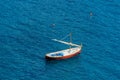 Small wooden boat with sail in the sea - Italy Royalty Free Stock Photo