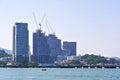 Small Wooden Boat in the Sea with Buildings Under Construction on Background Royalty Free Stock Photo