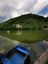 Small wooden boats with paddles on a lake with green mountains in the background Royalty Free Stock Photo