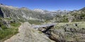 Small wooden bridge above steep narrow ravine and fast river in mountainous landscape of French Pyrenees, France, Europe