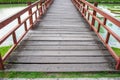 Small wooden bridge cross over the pond in garden park. Royalty Free Stock Photo