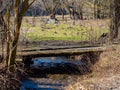 Small wooden bridge over a creek  in spring Royalty Free Stock Photo