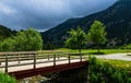 Small wooden bridge to the lake in Vall de Nuria valley Sanctuary in the Catalan Pyrenees, Spain Royalty Free Stock Photo