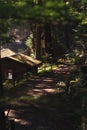 Small wooden cabin in the middle of a lush and dense forest, surrounded by trees in Okutama, Japan Royalty Free Stock Photo