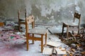 Small chairs among dirt and debris in abandoned kindergarten, dead city of Pripyat, Chernobyl NPP exclusion zone, Ukraine Royalty Free Stock Photo