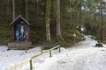 A small wooden chapel with a crucifix near the mountain path. Royalty Free Stock Photo