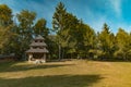 Small wooden chapel rural building edge of forest scenic environment meadow and golden trees foliage view in August summer time Royalty Free Stock Photo