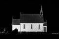 Old wooden church building at night. Black and white