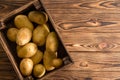 Small wooden crate filled with fresh potatoes Royalty Free Stock Photo