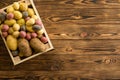 Small wooden crate filled with fresh potatoes Royalty Free Stock Photo