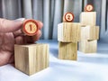 Small wooden cubes in columns, lined up in row. The concept of progressive movement in achieving the goal. Steps and Royalty Free Stock Photo