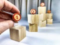 Small wooden cubes in columns, lined up in row. The concept of progressive movement in achieving the goal. Steps and Royalty Free Stock Photo