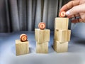 Small wooden cubes in columns, lined up in row. The concept of progressive movement in achieving the goal. Steps and Royalty Free Stock Photo