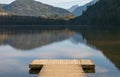 Small wooden dock at the lake, British Columbia isolated on the mountain background. Travel photo, nobody Royalty Free Stock Photo