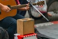 Small wooden donation box from a blind musician guitarist on street in Bangkok, Thailand