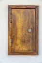 small wooden door inserted in the wall of a building to house an electricity meter or a water meter.