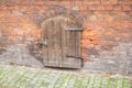 Small wooden door with lock in stone wall Royalty Free Stock Photo