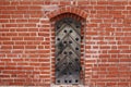 Small wooden door with many metal rivets in the brick wall Royalty Free Stock Photo