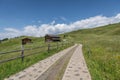 Small wooden farm house, cottage or log cabins on meadow on Alpe di Siusi, Seiser Alm, South Tyrol, Italy