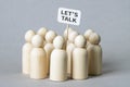Small wooden figures with a `Let`s Talk` poster Royalty Free Stock Photo