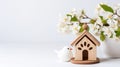 A small wooden house with a bird next to it, springtime arrangement with spring decor, copy-space Royalty Free Stock Photo